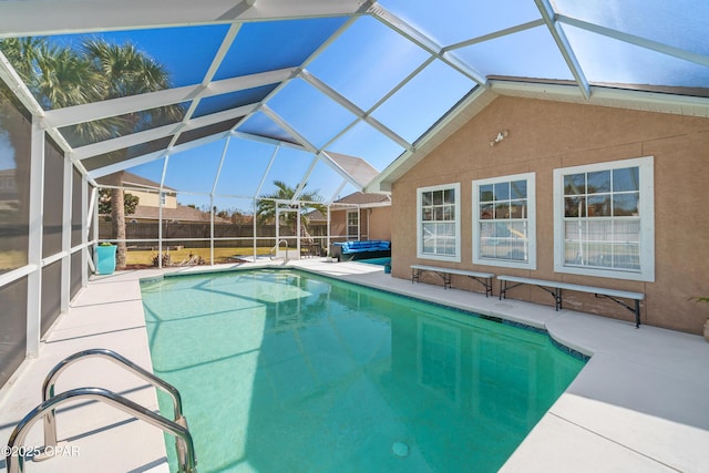 view of swimming pool with a patio area, glass enclosure, and a fenced in pool