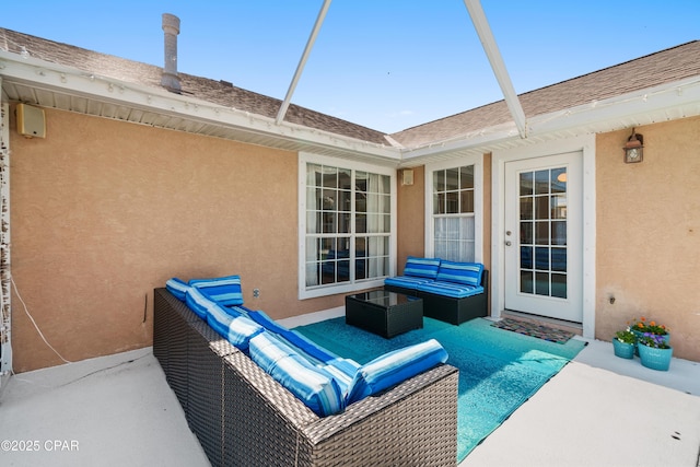 view of patio / terrace featuring glass enclosure and an outdoor living space