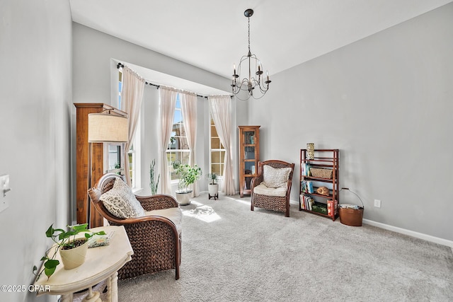 living area featuring carpet floors, baseboards, and a notable chandelier