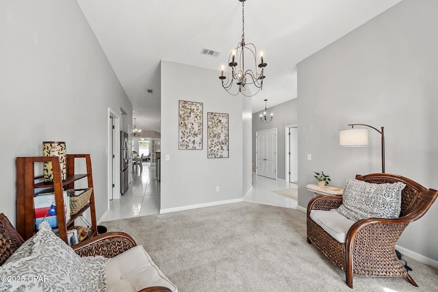 living area with light carpet, visible vents, baseboards, and an inviting chandelier