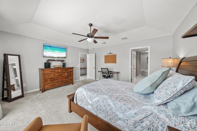 bedroom featuring lofted ceiling, light carpet, a ceiling fan, baseboards, and a tray ceiling