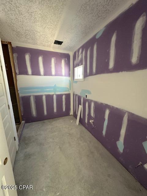 unfurnished bedroom featuring a textured ceiling