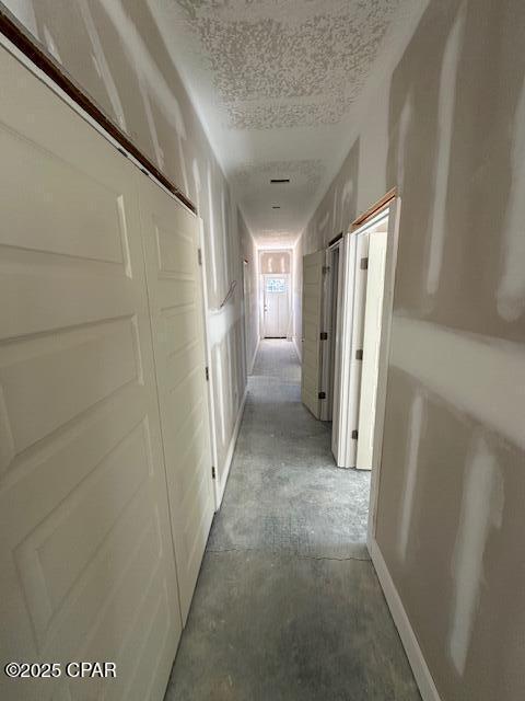 corridor with a textured ceiling