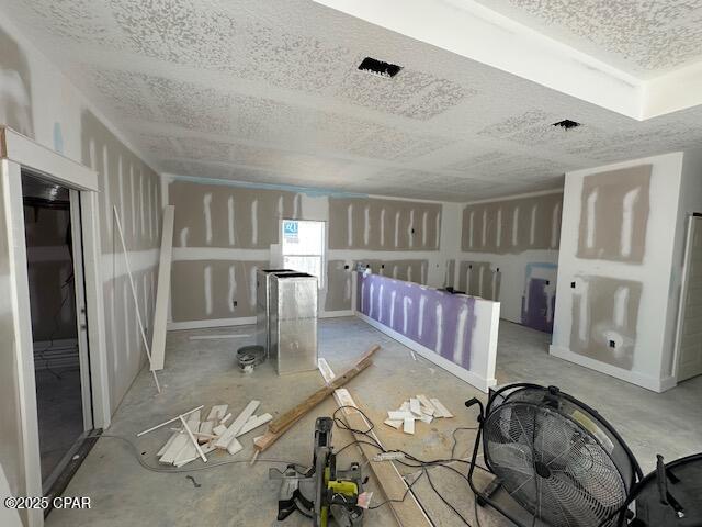 unfurnished room with a textured ceiling