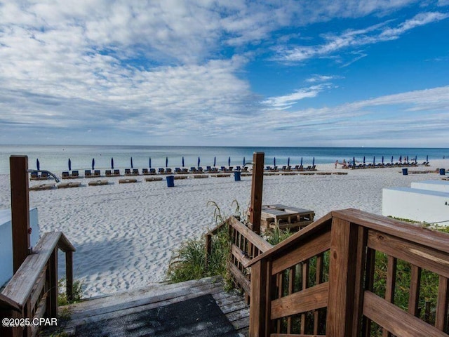 water view with a beach view and a boat dock