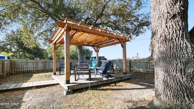 view of yard featuring a deck, a fenced backyard, and a pergola