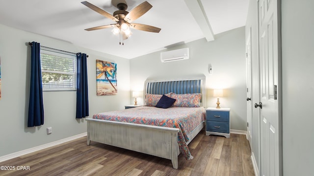 bedroom with beam ceiling, wood finished floors, baseboards, and a wall mounted AC