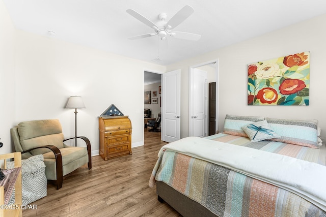 bedroom with ceiling fan, light wood-type flooring, and baseboards