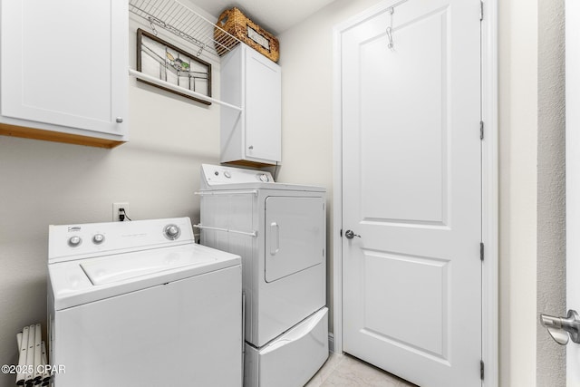 washroom featuring cabinet space and washing machine and dryer