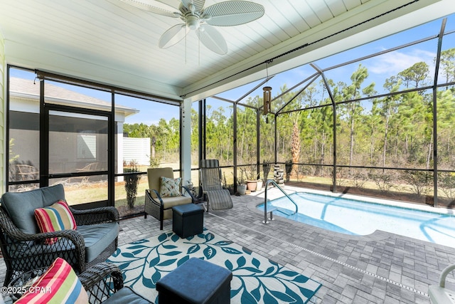 sunroom featuring ceiling fan