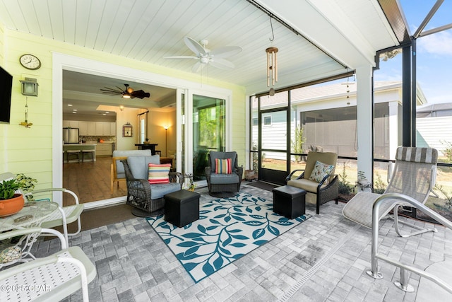 sunroom with a ceiling fan