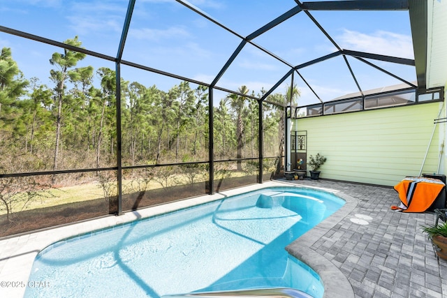 pool with a lanai and a patio area