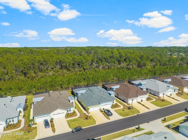 birds eye view of property with a forest view and a residential view