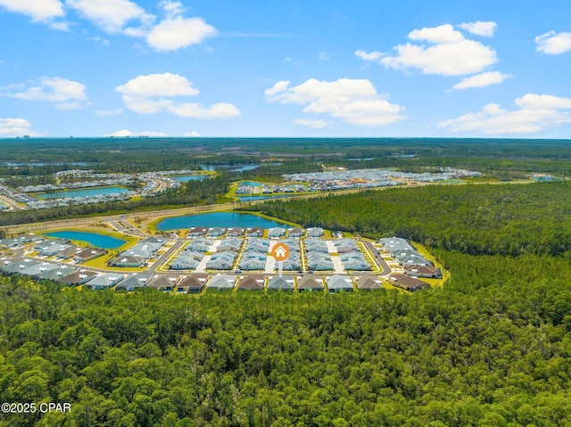 drone / aerial view with a water view and a wooded view