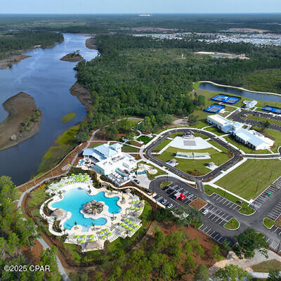 aerial view featuring a water view and a wooded view