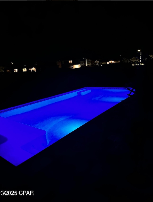 view of swimming pool with a fenced in pool