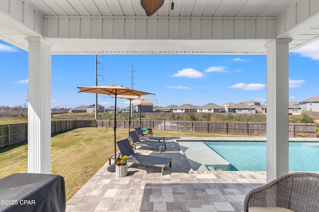 view of swimming pool with a patio, a fenced in pool, a yard, a fenced backyard, and a residential view