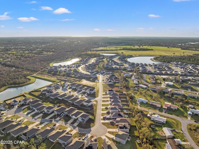 drone / aerial view with a residential view and a water view