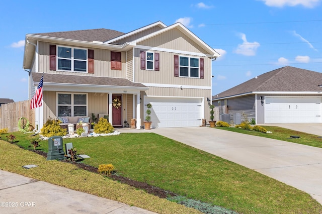 traditional-style home with a front yard, fence, driveway, an attached garage, and covered porch