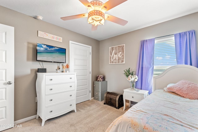 bedroom with light carpet, baseboards, and ceiling fan