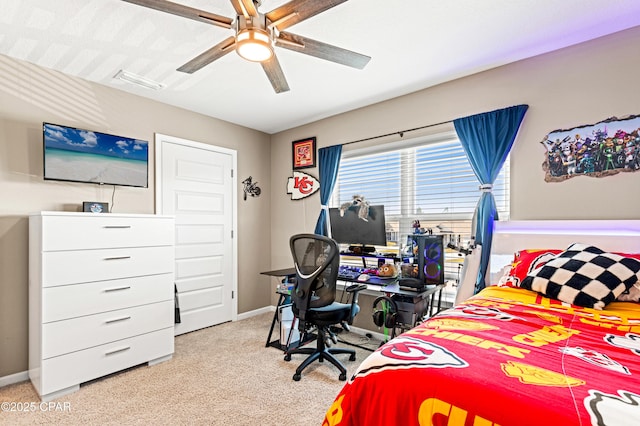 carpeted bedroom featuring visible vents, baseboards, and ceiling fan