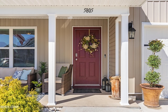 doorway to property with a porch and board and batten siding