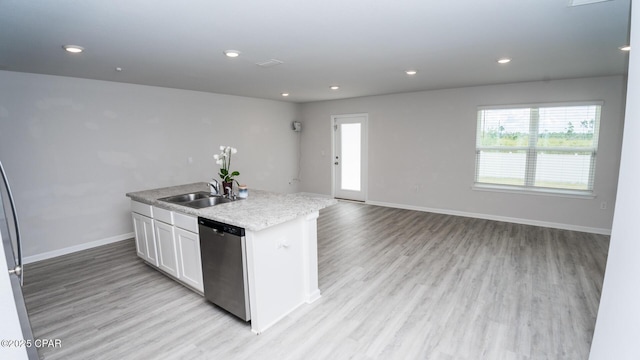 kitchen with baseboards, white cabinets, a kitchen island with sink, light wood-style floors, and stainless steel dishwasher