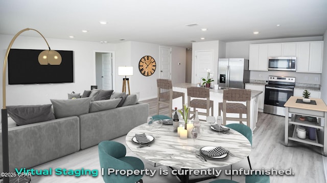 dining area featuring baseboards, recessed lighting, visible vents, and light wood-style floors