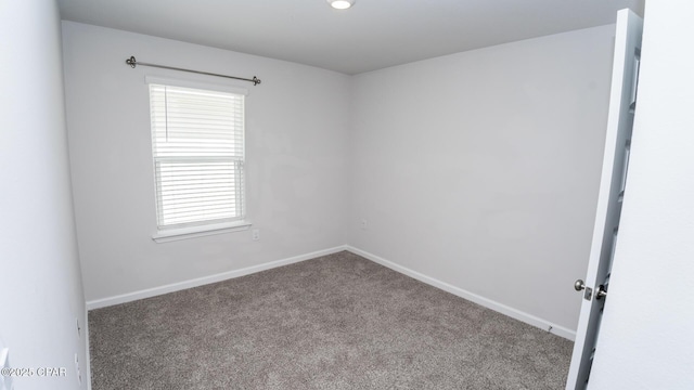 carpeted empty room with baseboards