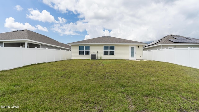 back of property with a yard and a fenced backyard