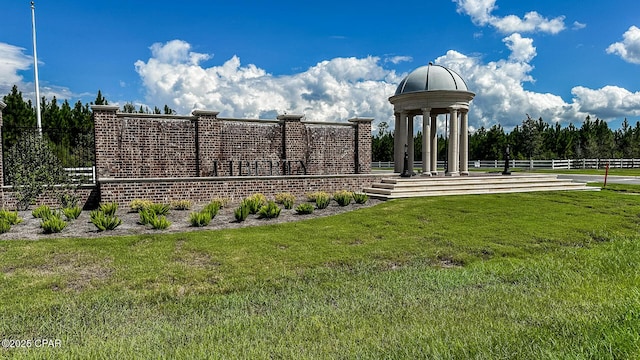 surrounding community with a lawn and fence