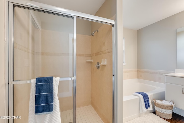 bathroom with a garden tub, a shower stall, and vanity