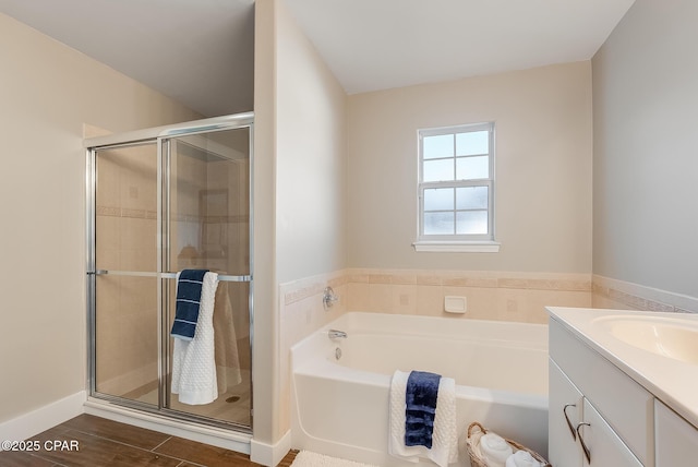 full bath featuring a shower stall, wood finished floors, a bath, and vanity