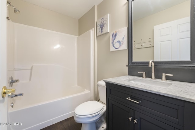 bathroom featuring washtub / shower combination, vanity, toilet, and wood finished floors