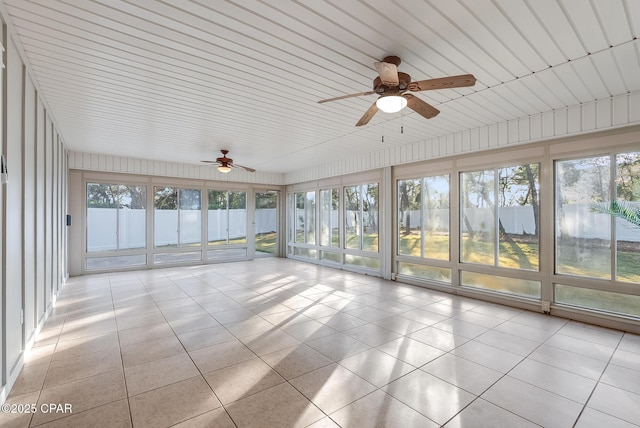 unfurnished sunroom with a healthy amount of sunlight and a ceiling fan