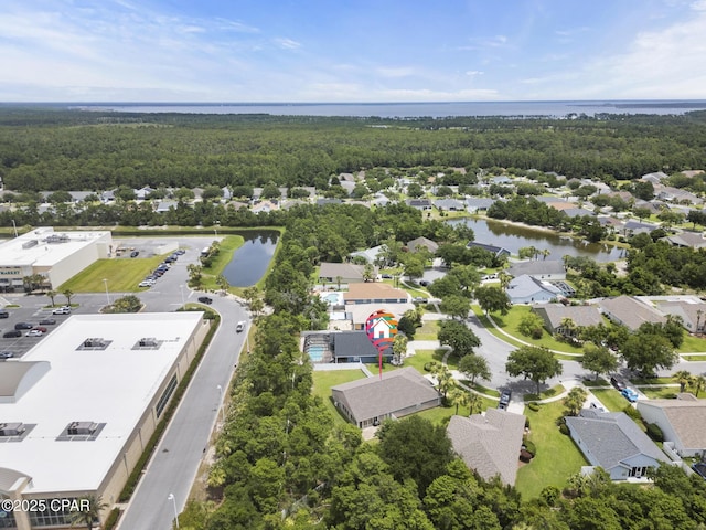 aerial view with a water view, a wooded view, and a residential view