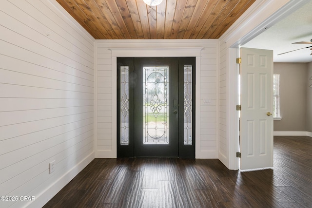 entrance foyer with dark wood-style floors, a wealth of natural light, wooden ceiling, and baseboards