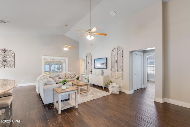 living area featuring high vaulted ceiling, plenty of natural light, visible vents, and dark wood-style flooring