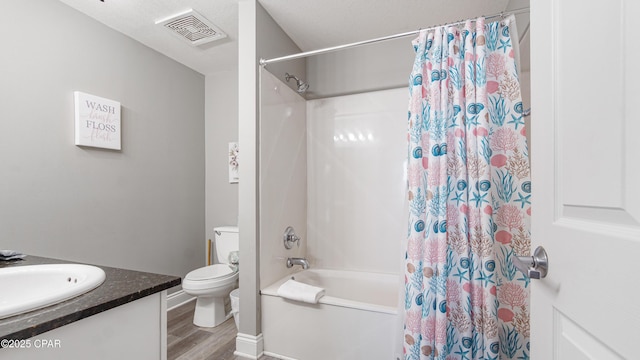 bathroom featuring vanity, shower / bathtub combination with curtain, wood finished floors, visible vents, and toilet