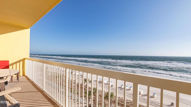 balcony with a beach view and a water view