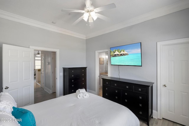 bedroom with crown molding, baseboards, ceiling fan, light wood-type flooring, and ensuite bath