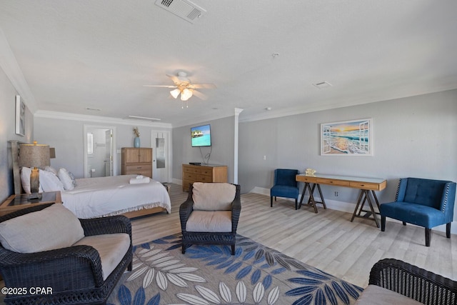 bedroom with visible vents, wood finished floors, and crown molding