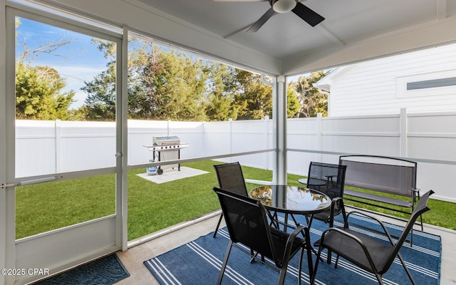 sunroom / solarium featuring ceiling fan