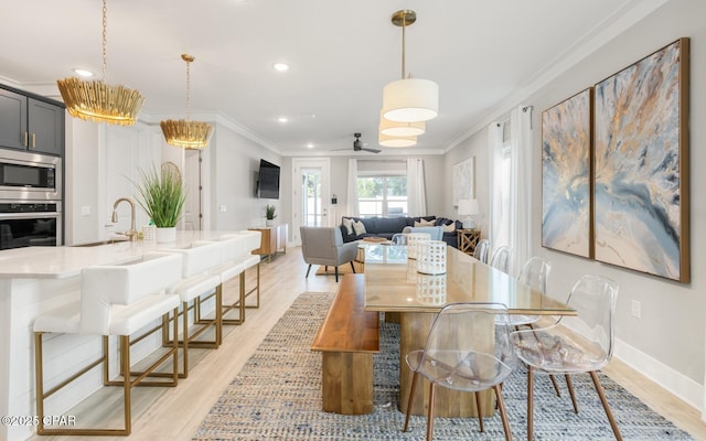 dining space featuring light wood finished floors, baseboards, ceiling fan, ornamental molding, and recessed lighting