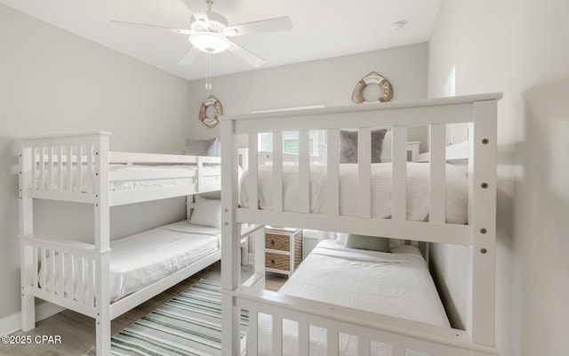 bedroom featuring a ceiling fan and wood finished floors