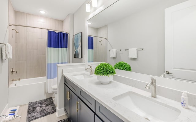 full bathroom with shower / bath combination with curtain, double vanity, a sink, and toilet