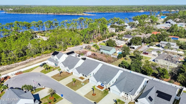 birds eye view of property with a residential view and a water view