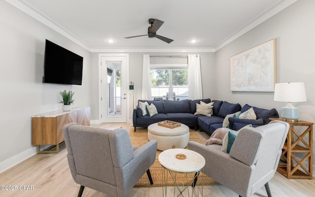 living room featuring light wood-style floors, baseboards, crown molding, and recessed lighting