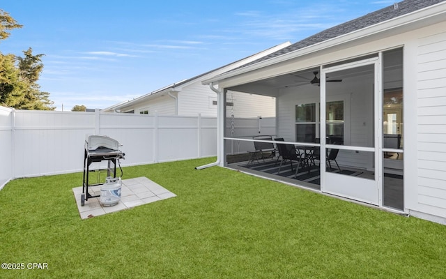 view of yard featuring a sunroom, fence, and a patio