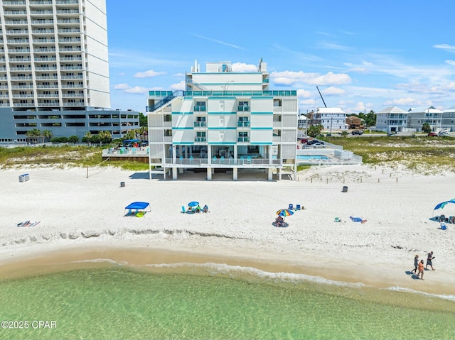 view of property featuring a view of the beach and a water view